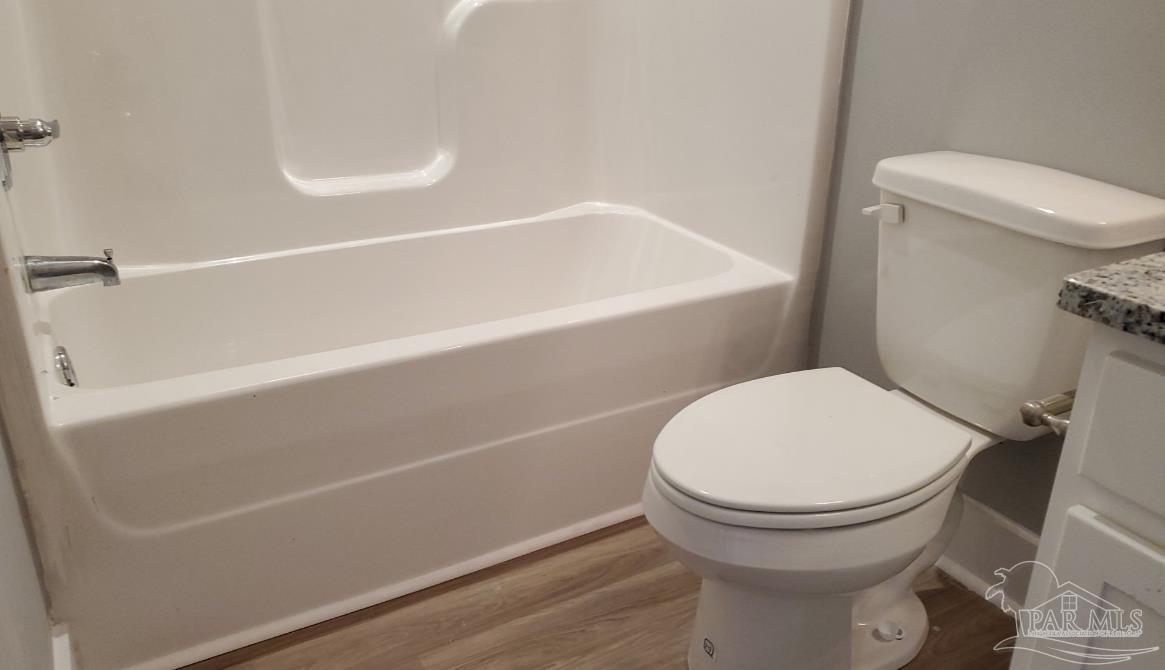 9822 Utopia Drive, Unit E Pensacola, FL 32514 - Photo 3 of 13 a bathroom with a toilet and a bathtub