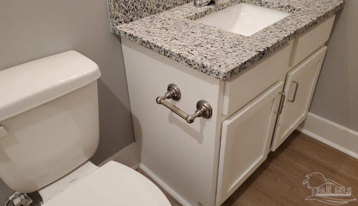9822 Utopia Drive, Unit E Pensacola, FL 32514 - Photo 4 of 13 a bathroom with a granite countertop sink and a toilet