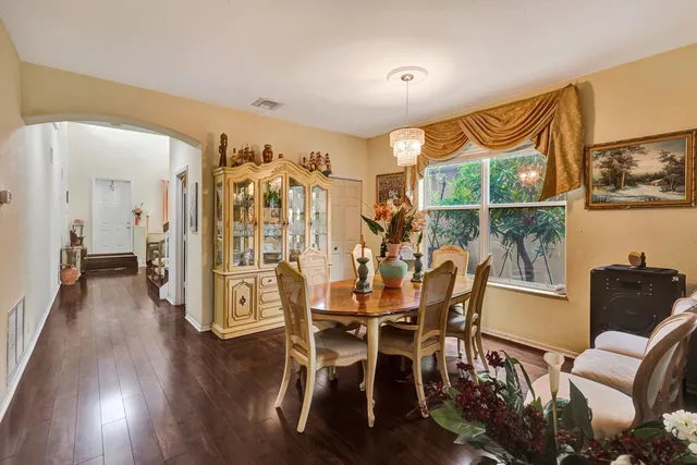 a dining room with furniture and wooden floor