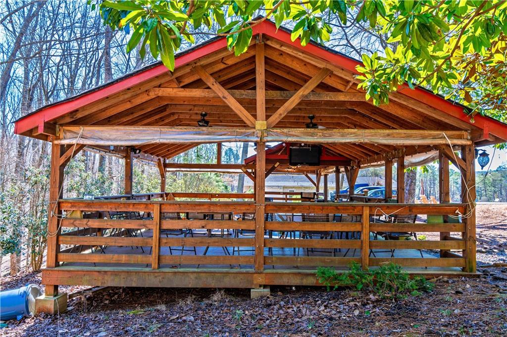 110 Rathgeb Trail Jasper, GA 30143 - Photo 26 of 62 a view of a roof deck with table and chairs under an umbrella
