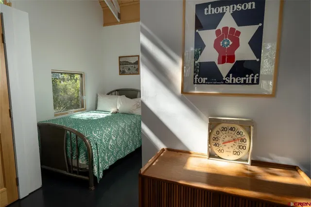 a bedroom with a bed and wall painting