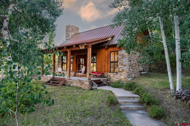 a view of a chair and table in backyard of the house