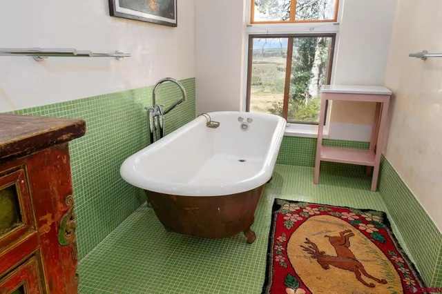 a bathroom with a sink a mirror and a bathtub