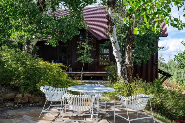 a view of a chairs and table in the patio