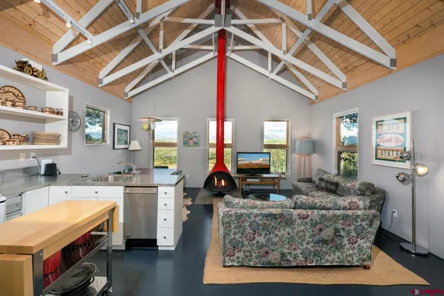 a living room with fireplace furniture and a flat screen tv