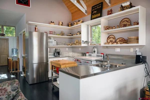 a kitchen with stainless steel appliances a sink and cabinets