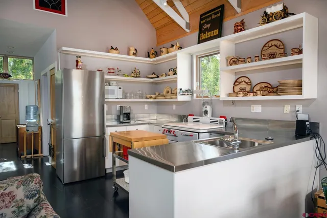 a kitchen with stainless steel appliances a sink and cabinets