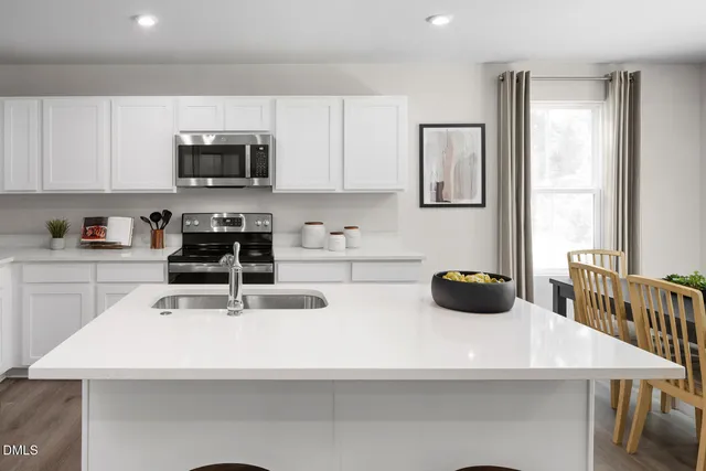 a kitchen with stainless steel appliances a sink a microwave and cabinets