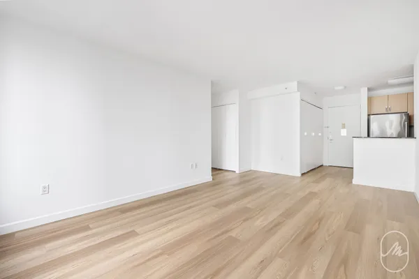 a view of empty room with wooden floor