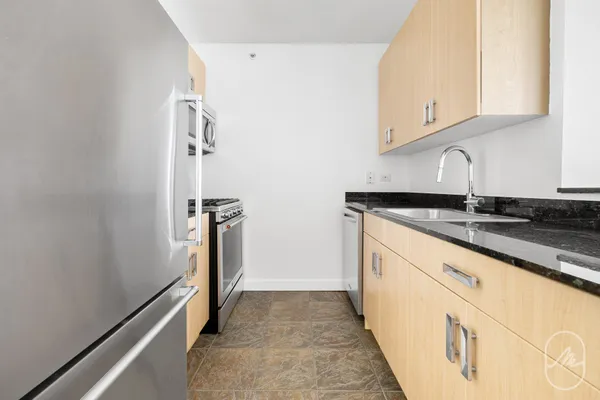 a view of a kitchen with granite countertop cabinets