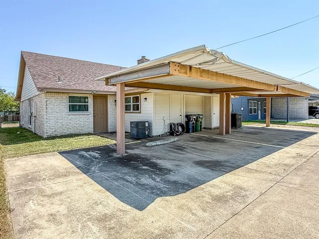 a view of a white house with a outdoor space