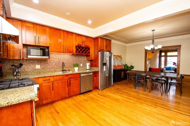 a large kitchen with kitchen island a sink table and chairs
