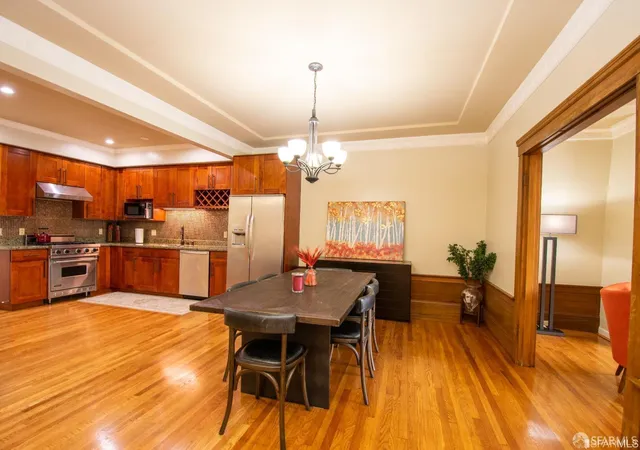 a view of a dining room with furniture and a chandelier