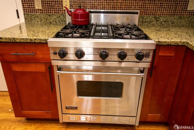 a stove top oven sitting inside of a kitchen