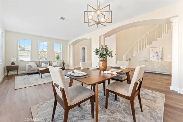 a view of a dining room with furniture and wooden floor