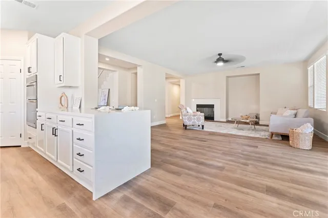 a living room with furniture and a dresser with wooden floor