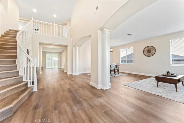 a view of a hallway view with wooden floor and staircase