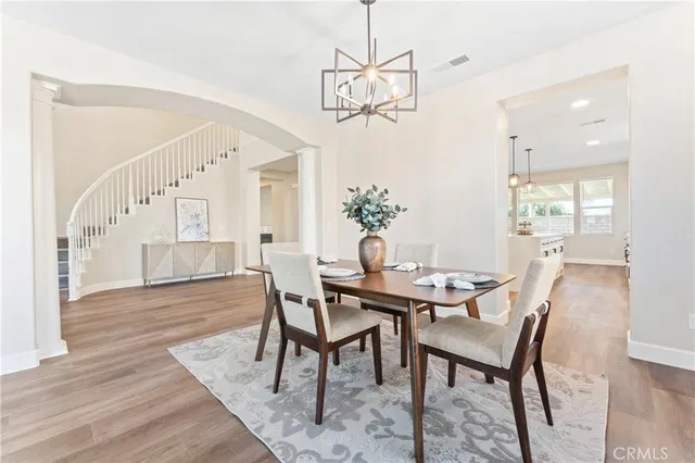 a view of a dining room with furniture and wooden floor
