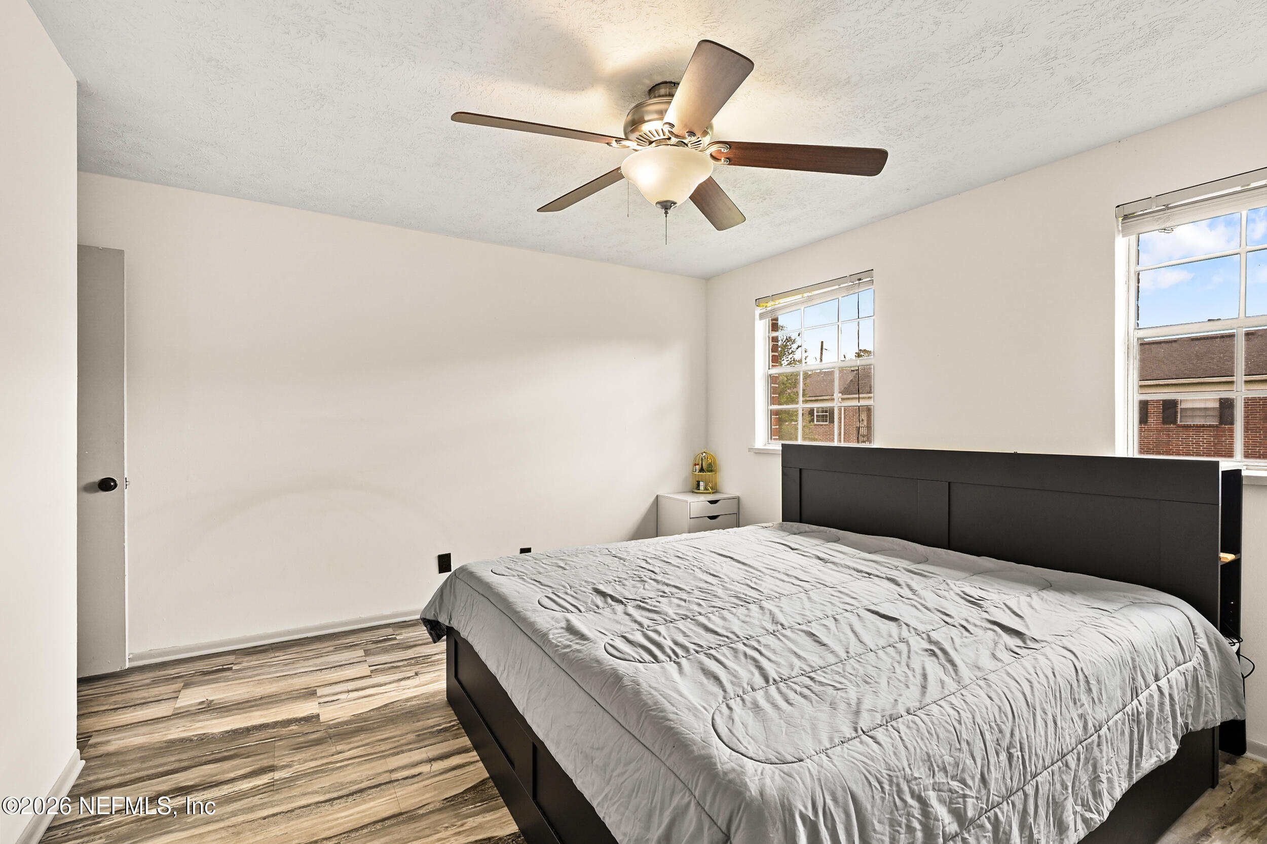 4915 Baymeadows Road, Unit 6G Jacksonville, FL 32217 - Photo 17 of 44 a bedroom with a large bed and a ceiling fan