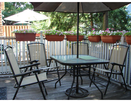 a view of a chairs and table in patio with a fire pit