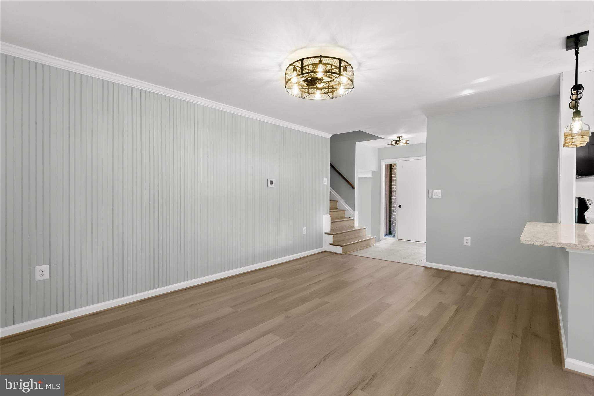 9511 Wandering Way Columbia, MD 21045 - Photo 22 of 62 a view of an empty room and wooden floor