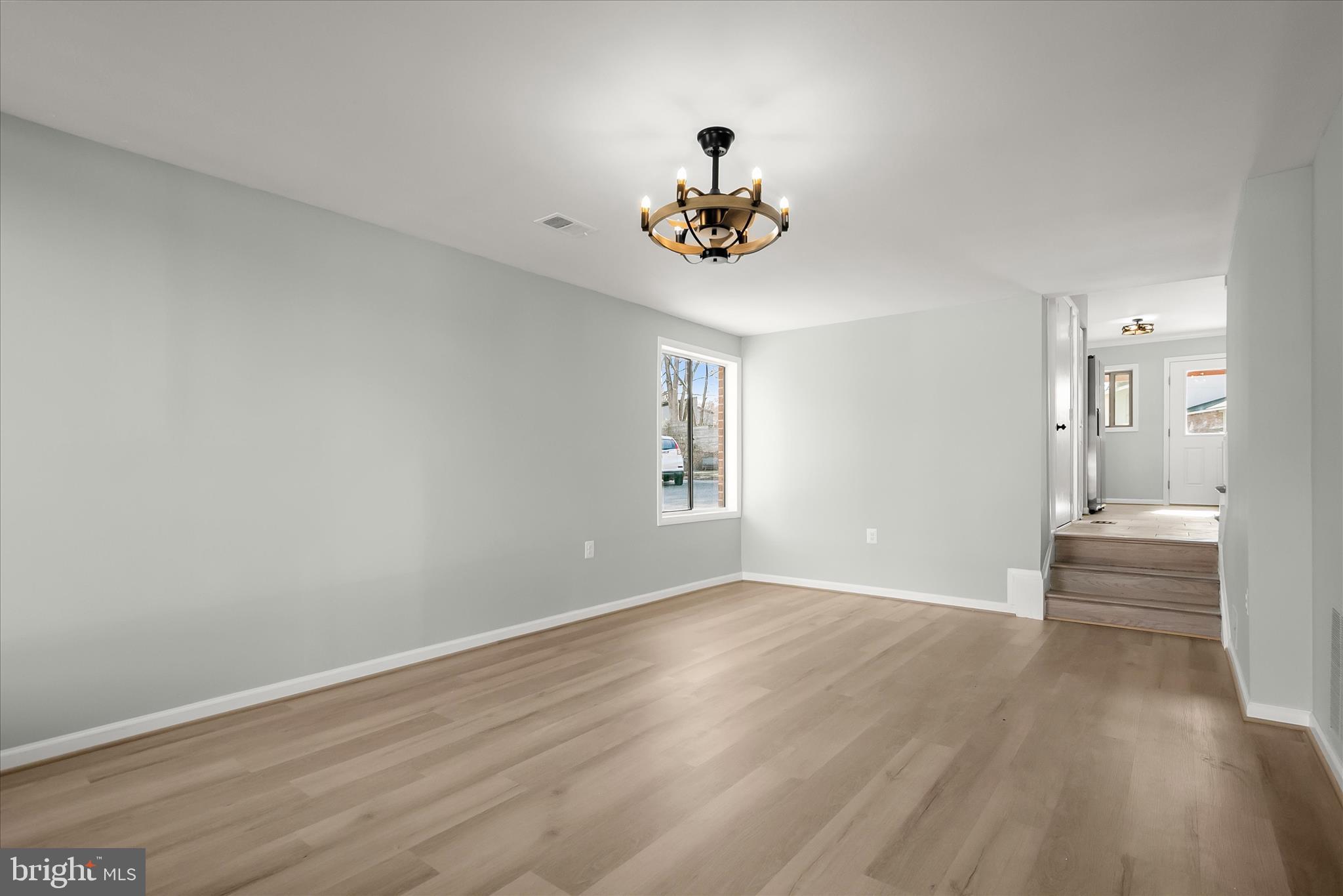 9511 Wandering Way Columbia, MD 21045 - Photo 29 of 62 a view of an empty room with wooden floor