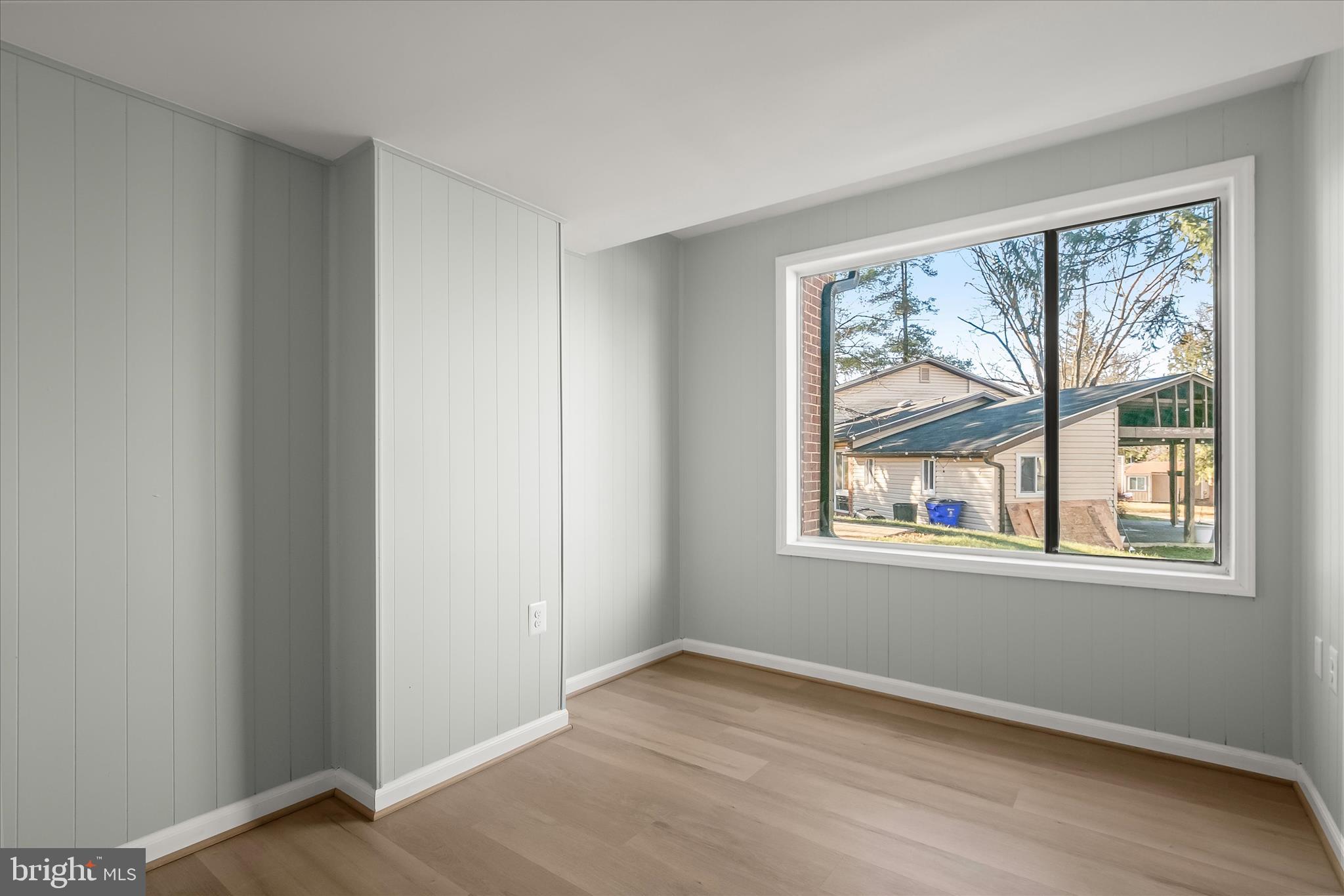 9511 Wandering Way Columbia, MD 21045 - Photo 33 of 62 an empty room with wooden floor and windows