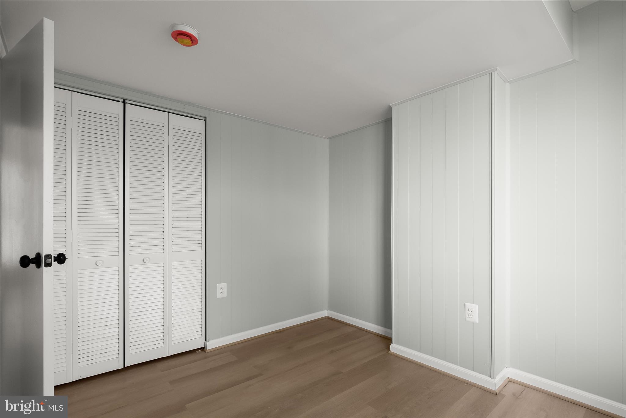 9511 Wandering Way Columbia, MD 21045 - Photo 36 of 62 an empty room with wooden floor and sliding door