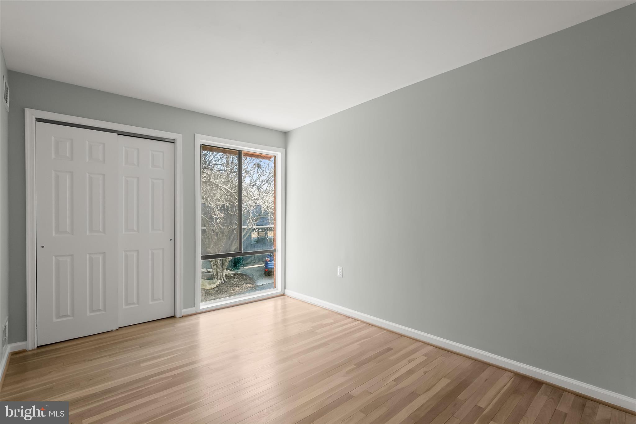 9511 Wandering Way Columbia, MD 21045 - Photo 39 of 62 an empty room with wooden floor and windows