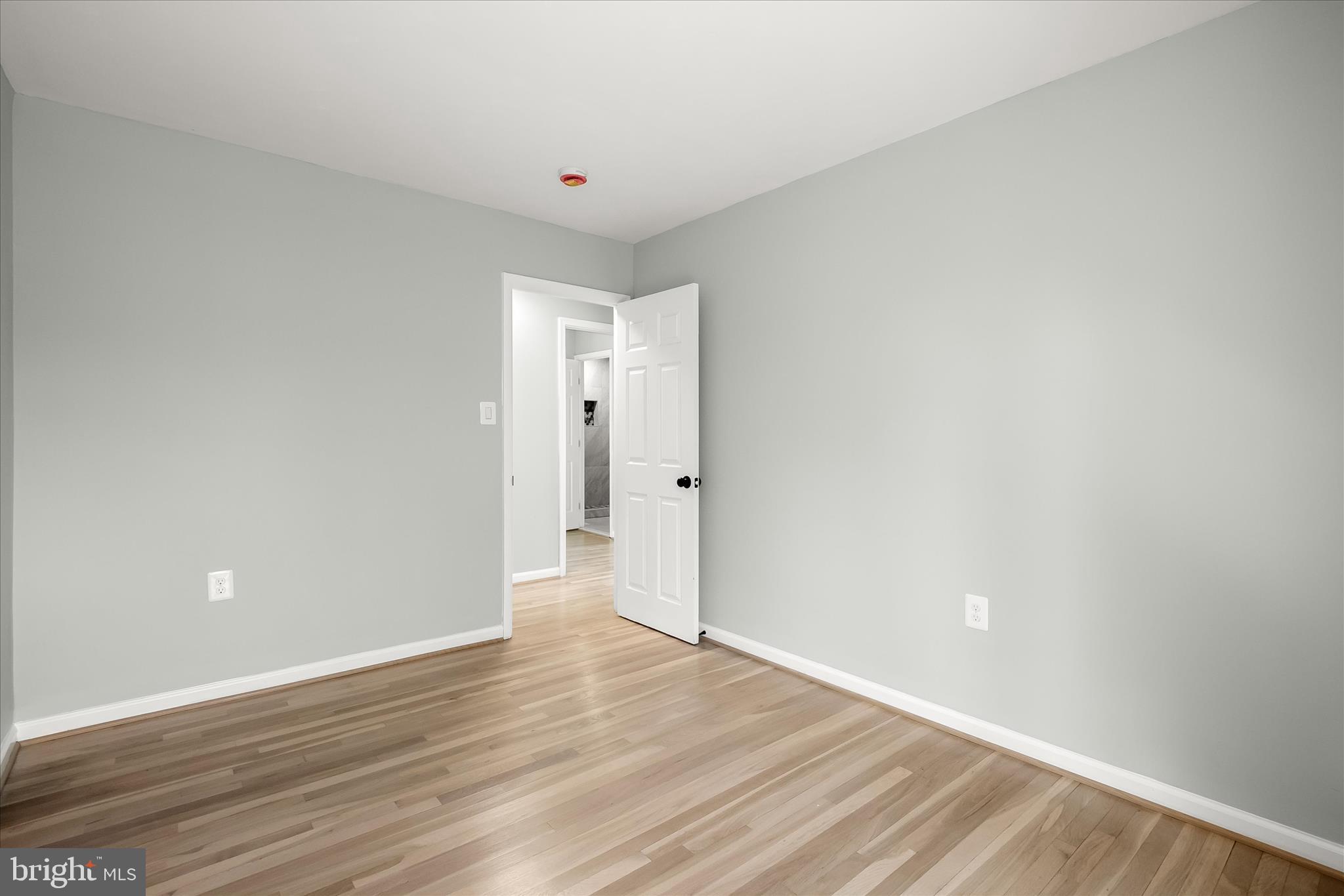 9511 Wandering Way Columbia, MD 21045 - Photo 40 of 62 a view of an empty room and wooden floor