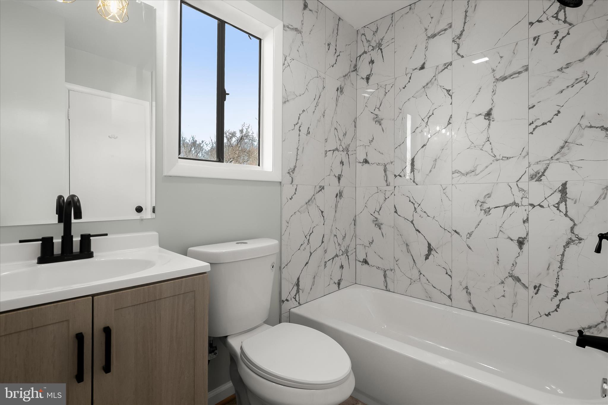 9511 Wandering Way Columbia, MD 21045 - Photo 42 of 62 a bathroom with a bathtub sink vanity mirror and toilet