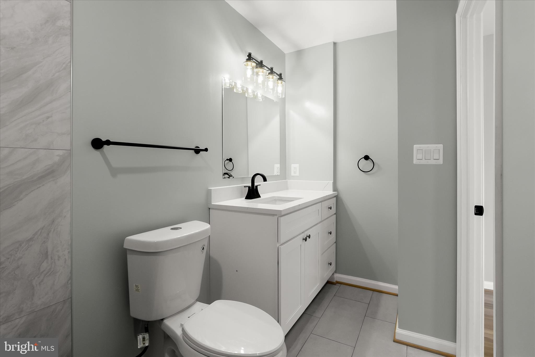 9511 Wandering Way Columbia, MD 21045 - Photo 54 of 62 a bathroom with a toilet sink and mirror