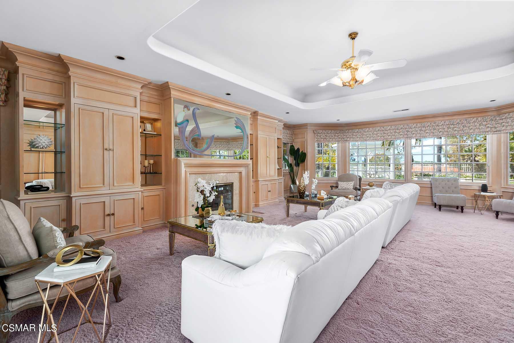 5467 Wellesley Drive Calabasas, CA 91302 - Photo 15 of 60 a living room with furniture fireplace and a large window