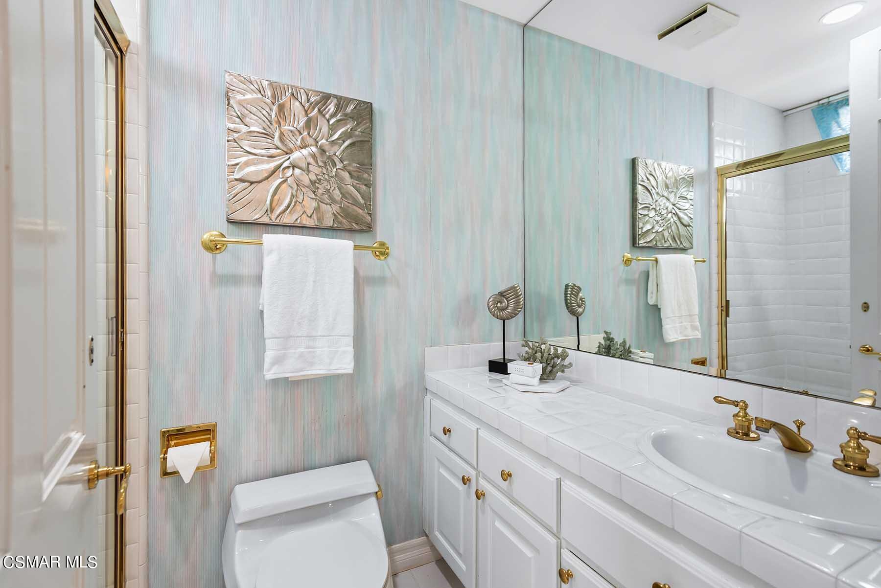 5467 Wellesley Drive Calabasas, CA 91302 - Photo 23 of 60 a bathroom with a double vanity sink mirror and shower