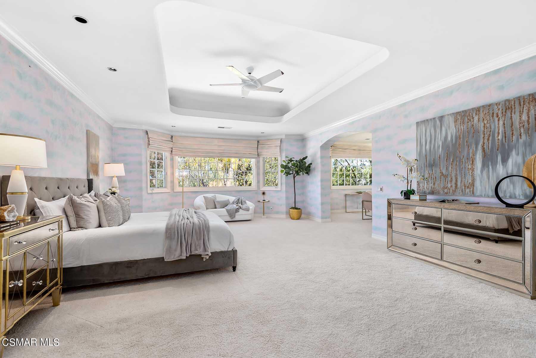 5467 Wellesley Drive Calabasas, CA 91302 - Photo 33 of 60 a bed room with a bed and a chandelier