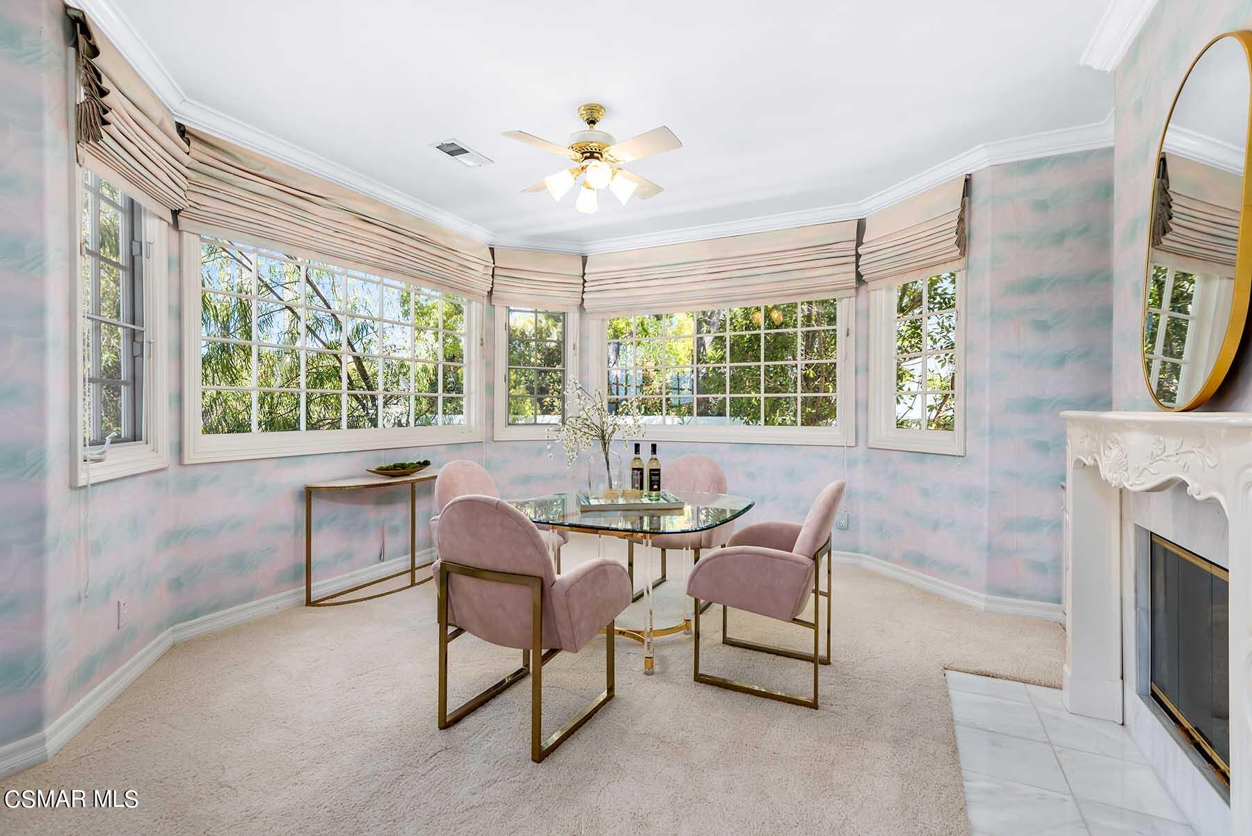 5467 Wellesley Drive Calabasas, CA 91302 - Photo 35 of 60 a dining room with furniture a fireplace and a chandelier