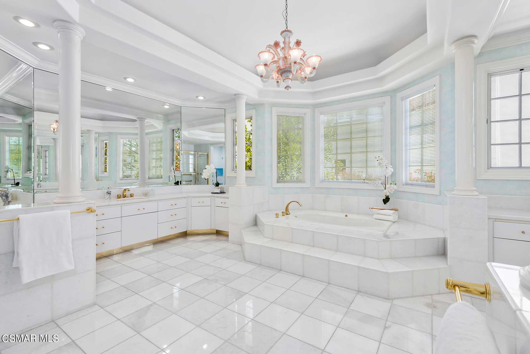 5467 Wellesley Drive Calabasas, CA 91302 - Photo 40 of 60 a large white bathroom with a large tub sink and vanity