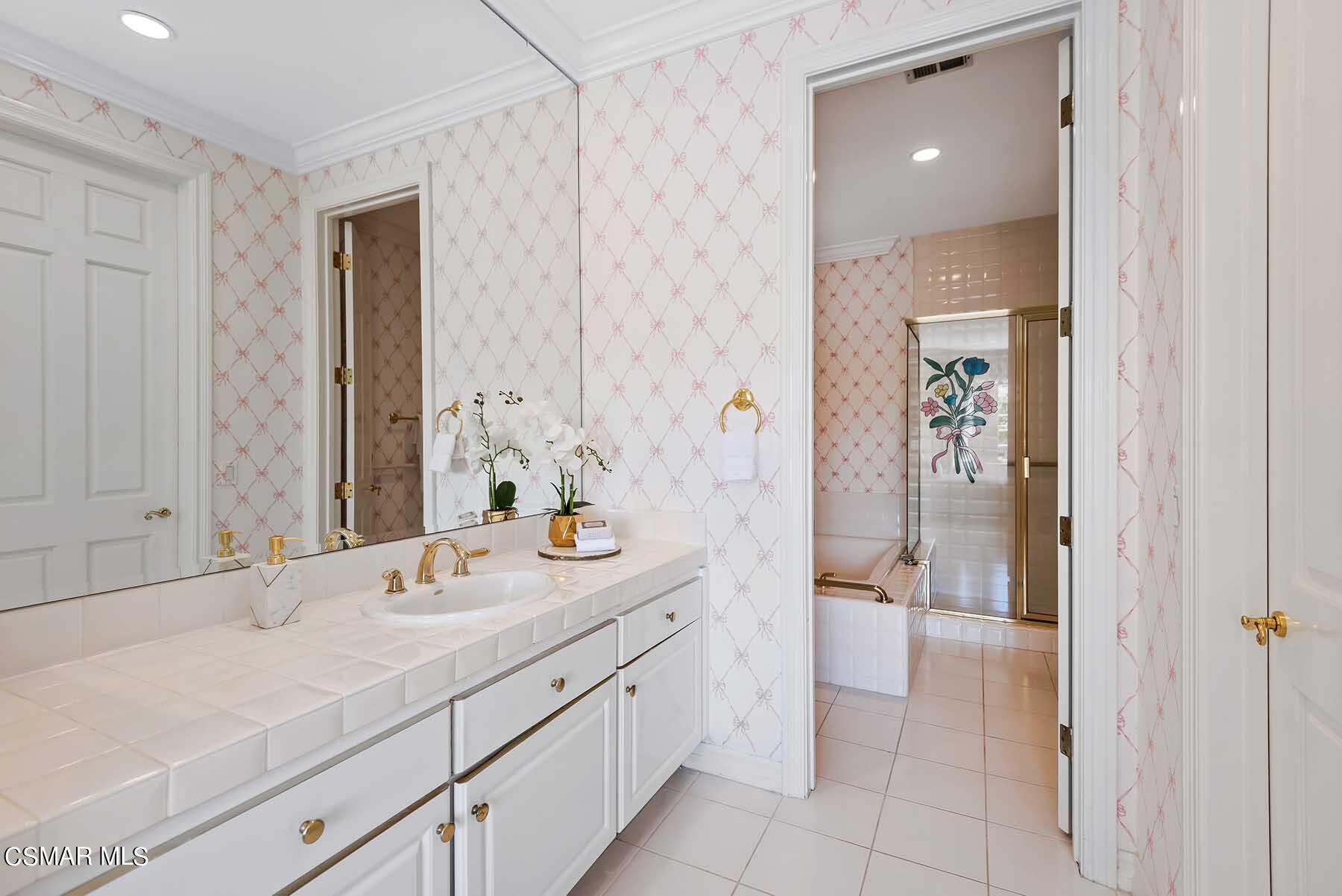 5467 Wellesley Drive Calabasas, CA 91302 - Photo 43 of 60 a spacious bathroom with a double vanity sink a mirror and a shower