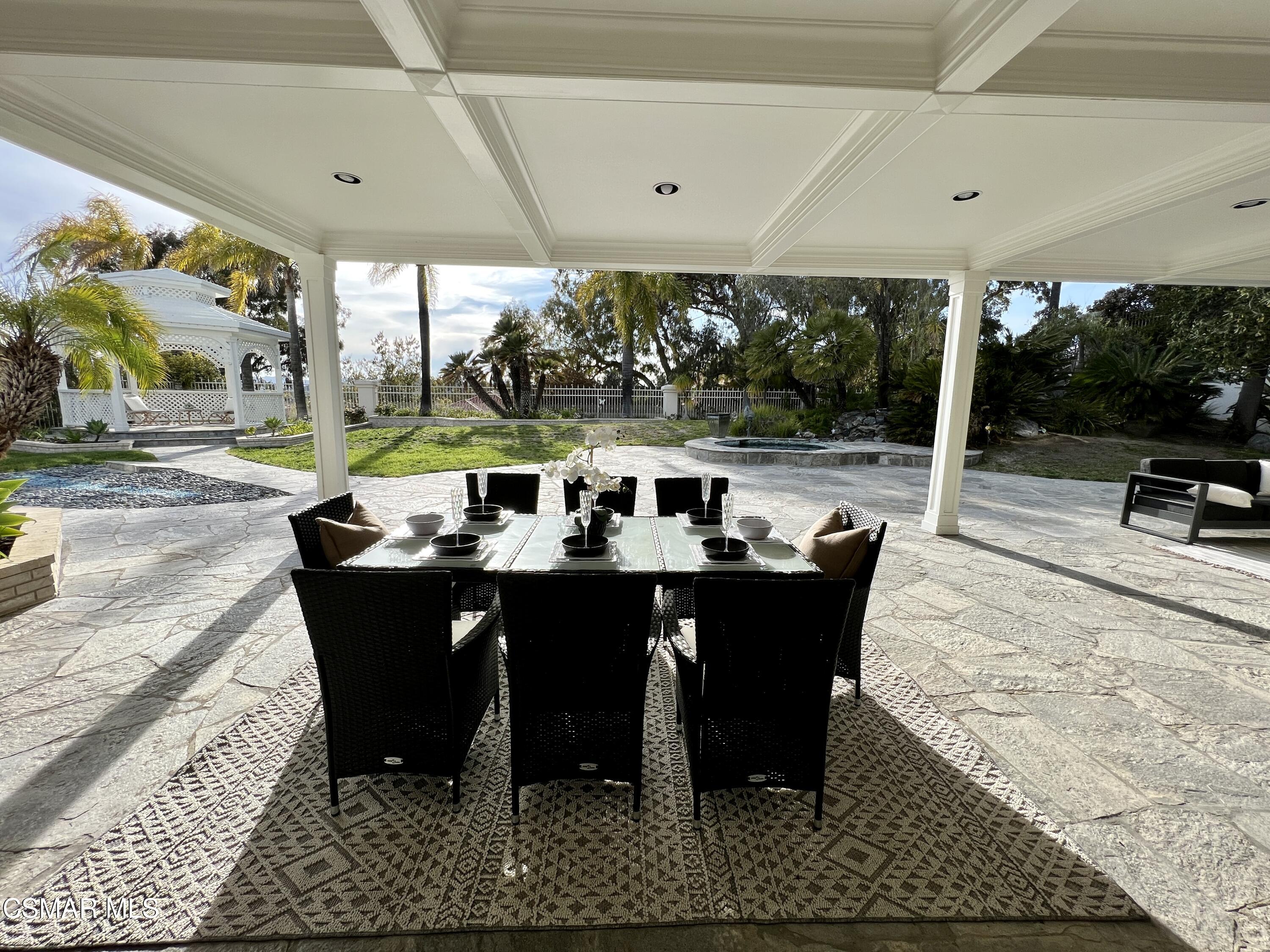 5467 Wellesley Drive Calabasas, CA 91302 - Photo 49 of 60 a view of a patio with a dining table and chairs