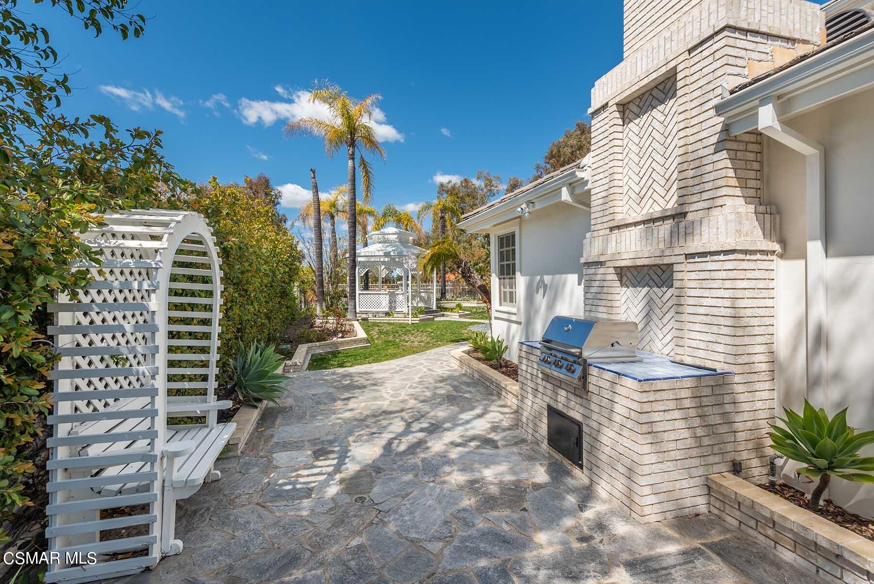 5467 Wellesley Drive Calabasas, CA 91302 - Photo 54 of 60 a view of a house with a yard