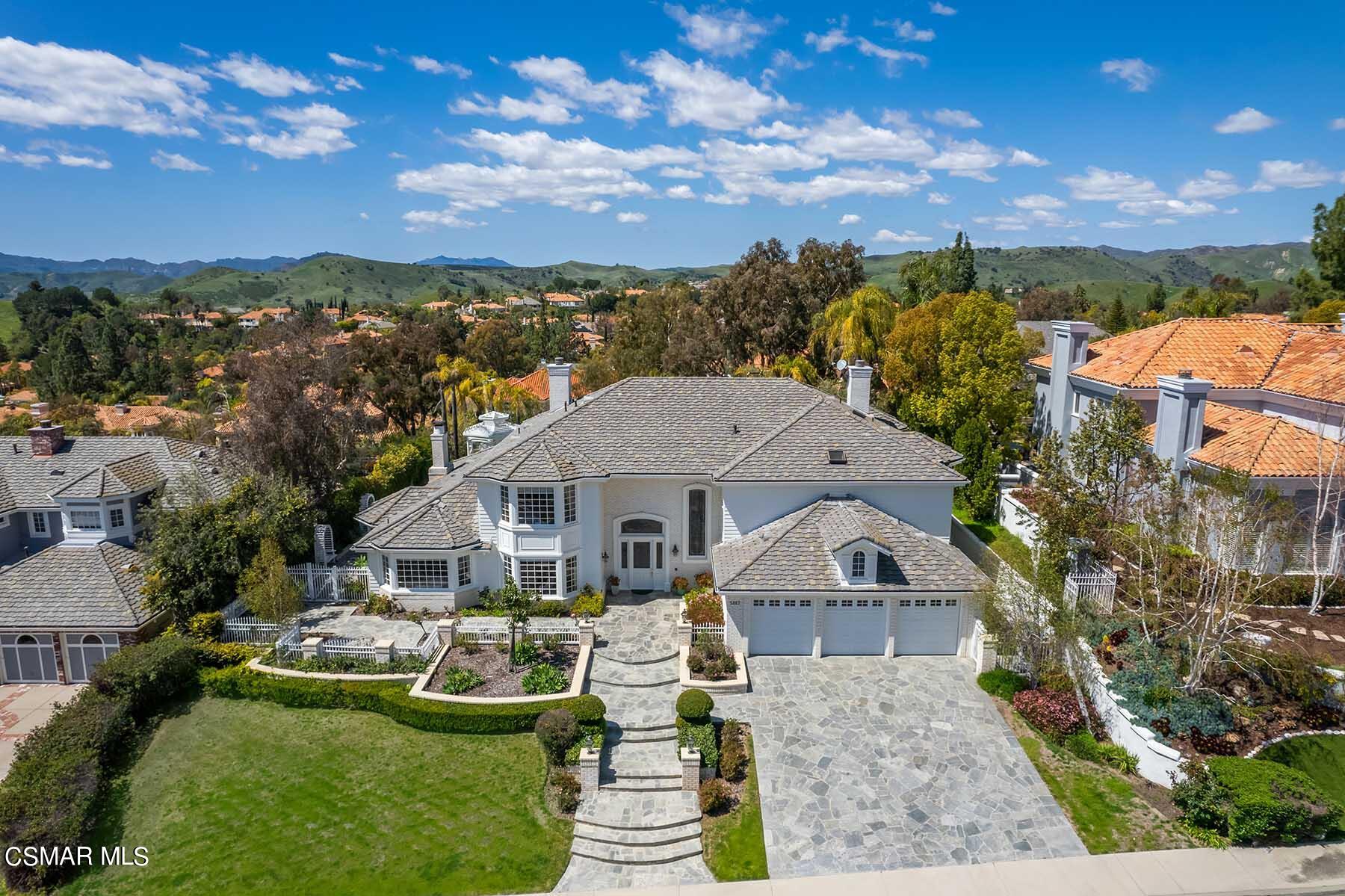 5467 Wellesley Drive Calabasas, CA 91302 - Photo 55 of 60 a front view of house with a garden and lake view