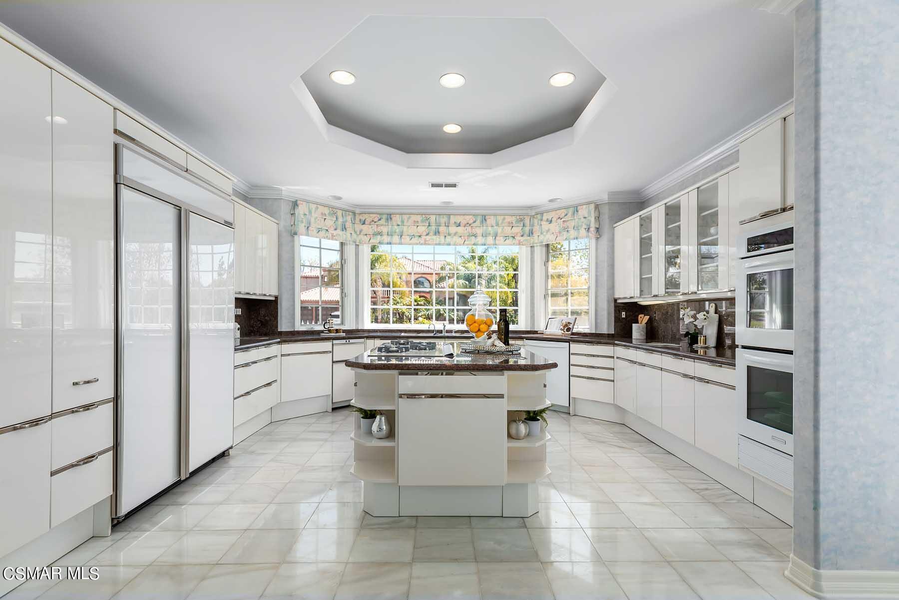 5467 Wellesley Drive Calabasas, CA 91302 - Photo 10 of 60 a large kitchen with stainless steel appliances lots of white cabinets