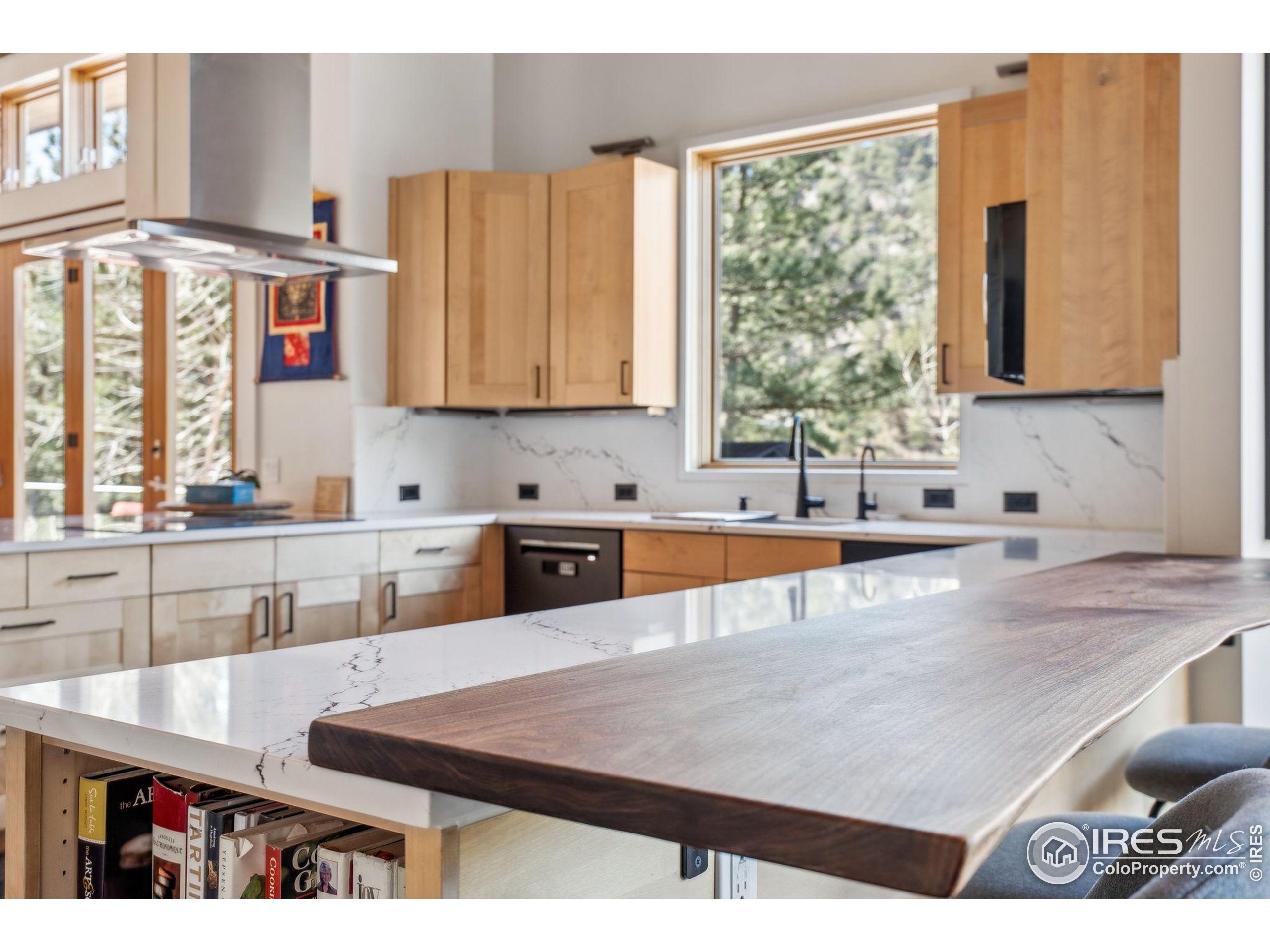 1127 Valley Lane Boulder, CO 80302 - Photo 16 of 48 a kitchen with stainless steel appliances kitchen island granite countertop a sink a counter space and cabinets