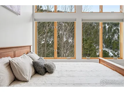 a spacious bedroom with a large bed and a large window