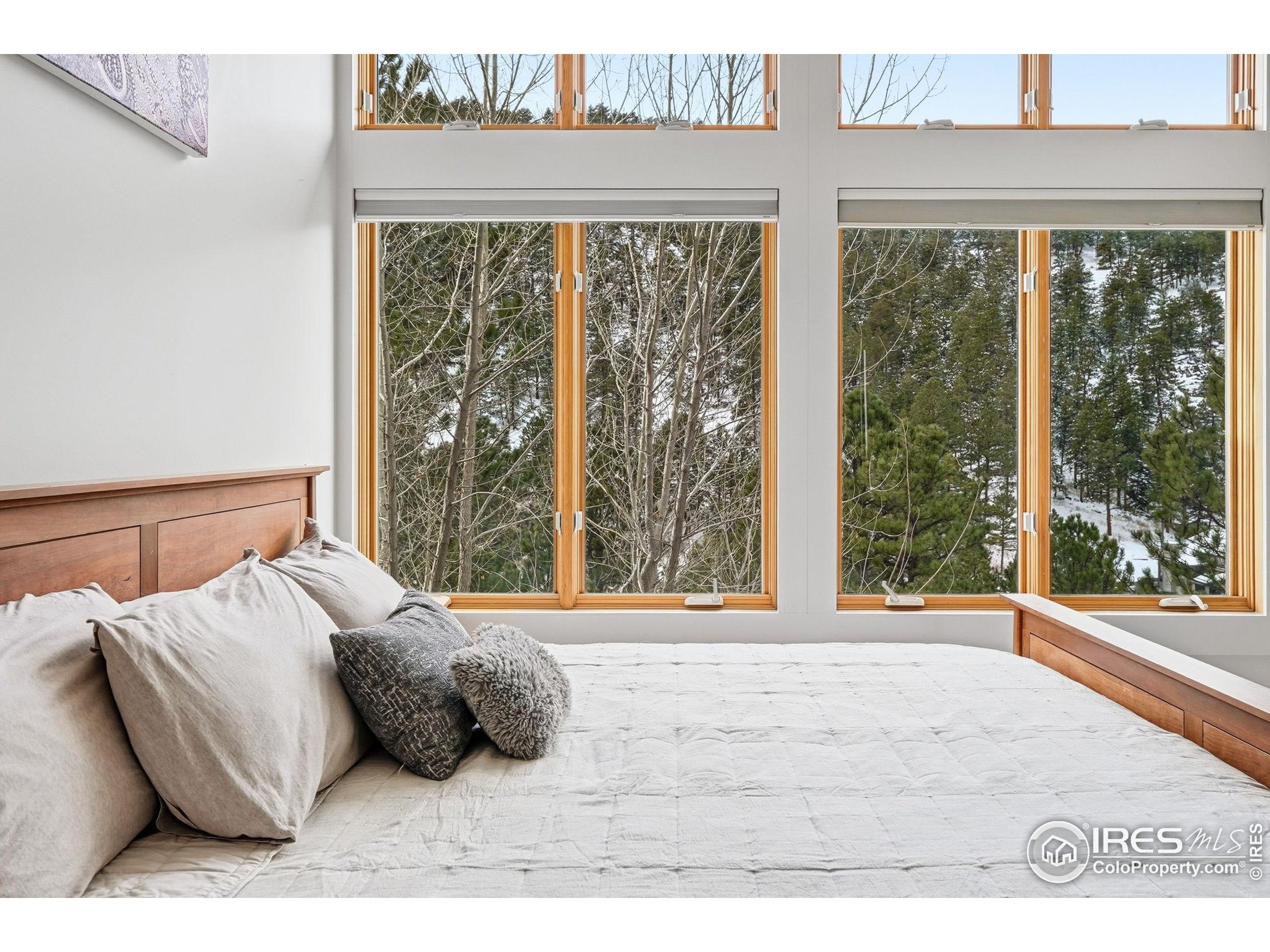 1127 Valley Lane Boulder, CO 80302 - Photo 24 of 48 a bed sitting in a bedroom next to a window