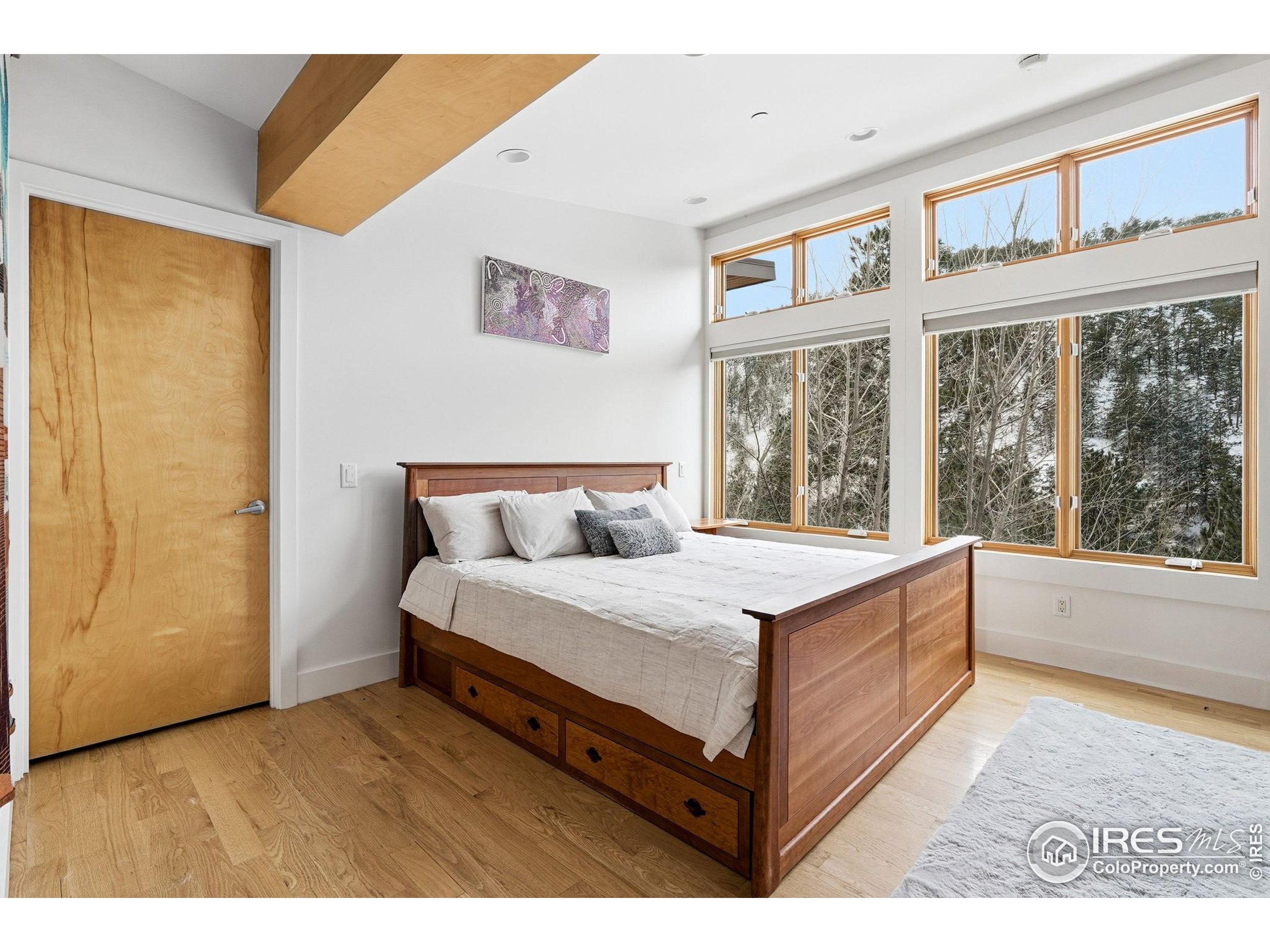 1127 Valley Lane Boulder, CO 80302 - Photo 25 of 48 a spacious bedroom with a large bed and a large window