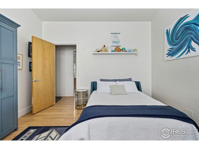 a bedroom with furniture and a large window