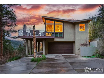a view of a house with a porch and a yard
