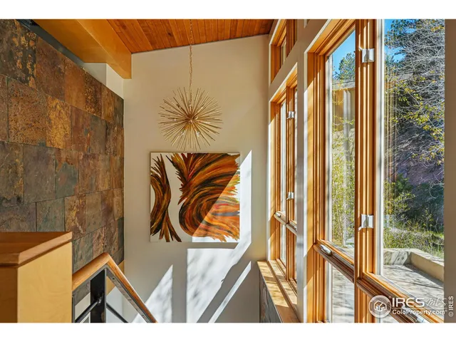 a living room with patio furniture and a floor to ceiling window