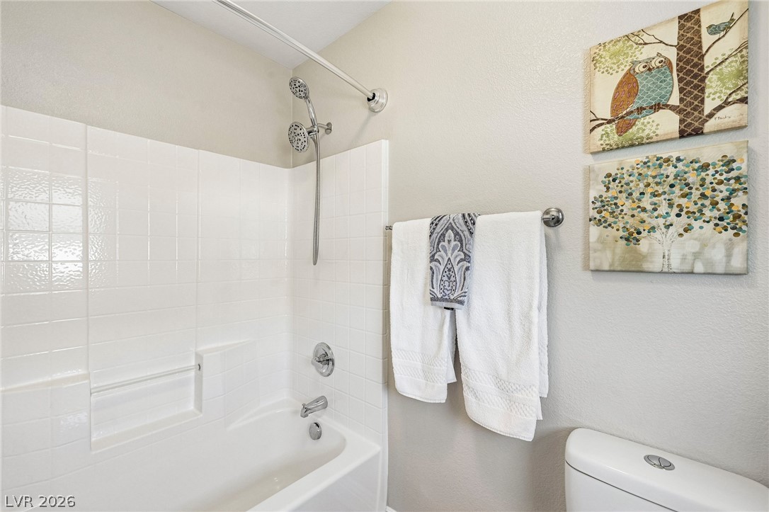 1176 Butternut Ranch Court Henderson, NV 89052 - Photo 30 of 60 A well-maintained bathroom with a pristine tub-shower combo, complete with a dual shower head.